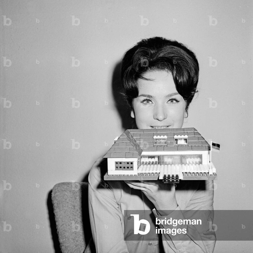 German TV speaker and presenter Brigitte Gerloff constructing a house with lego toy bricks, Germany 1960s
