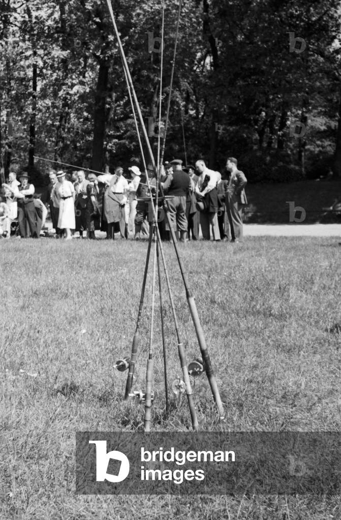 Angling rods put together as a tent at a lawn, Germany 1930s (b/w photo)