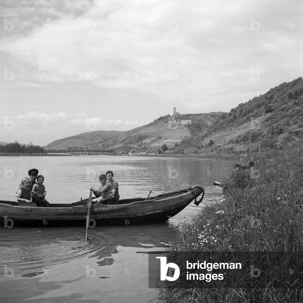 Family on a rowing boat on river Neckar near Hornberg, Germany 1930s (b/w photo)