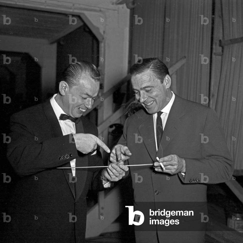 Two man playing with a conductor's baton at Hamburg, Germany 1950s