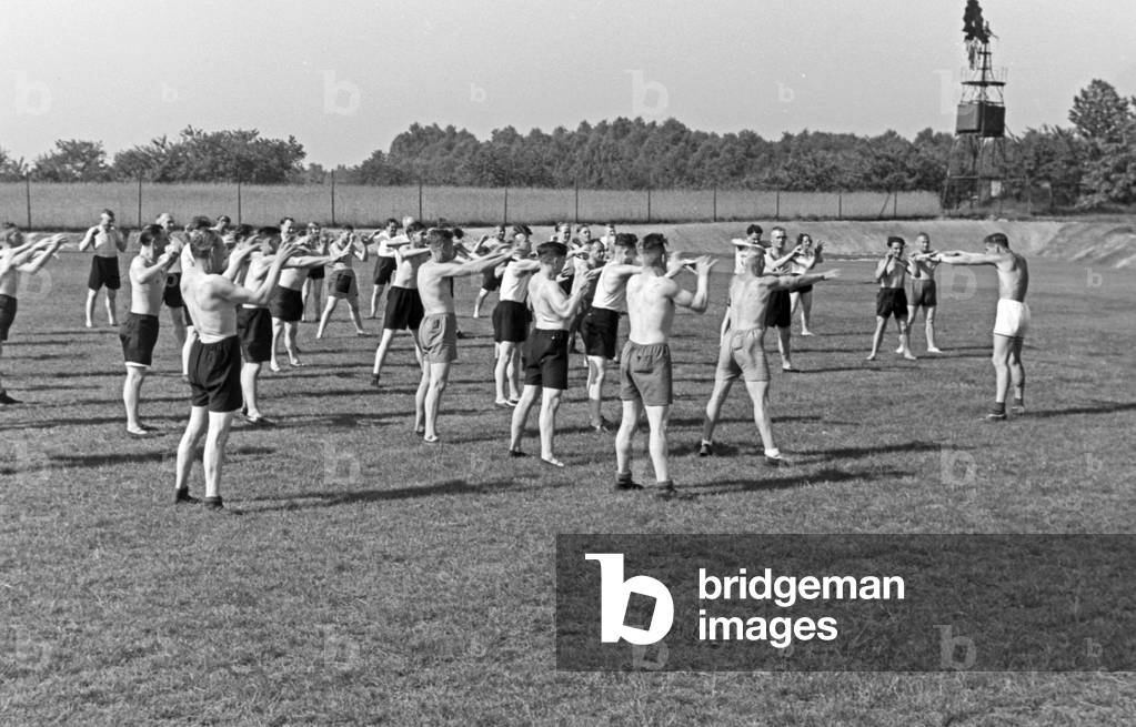 A grou of young men doing their early morning exercise, Germany 1930s (b/w photo)