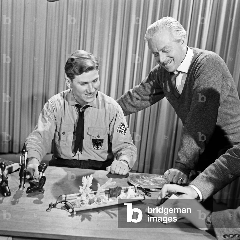 German boy scout Helfried Weyer (left) explaining African tribal art at German TV station NDR at Hamburg, Germany 1960s