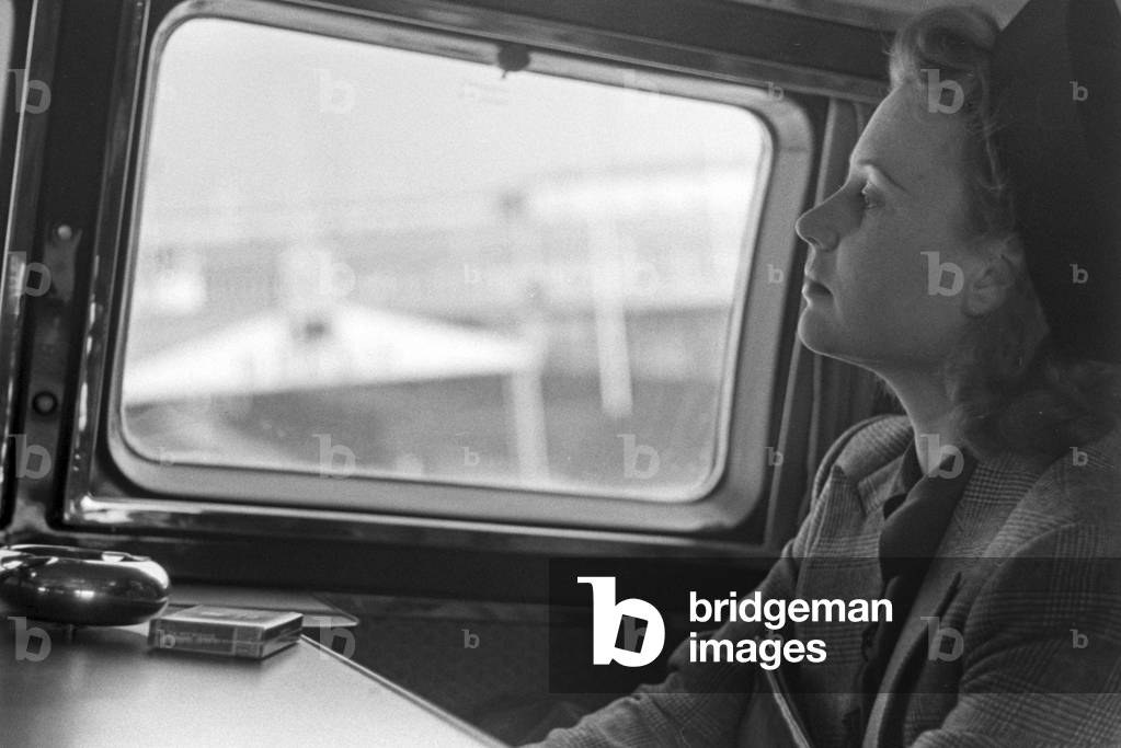A woman sitting in a plane, ready for taking off from Berlin Tempelhof airport, Germany 1930s (b/w photo)