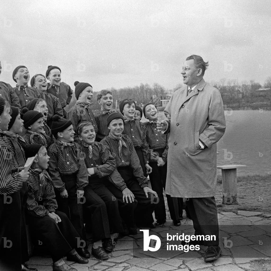 German composer Michael Jary singing with a children's choir at Hamburg, Germany 1960s