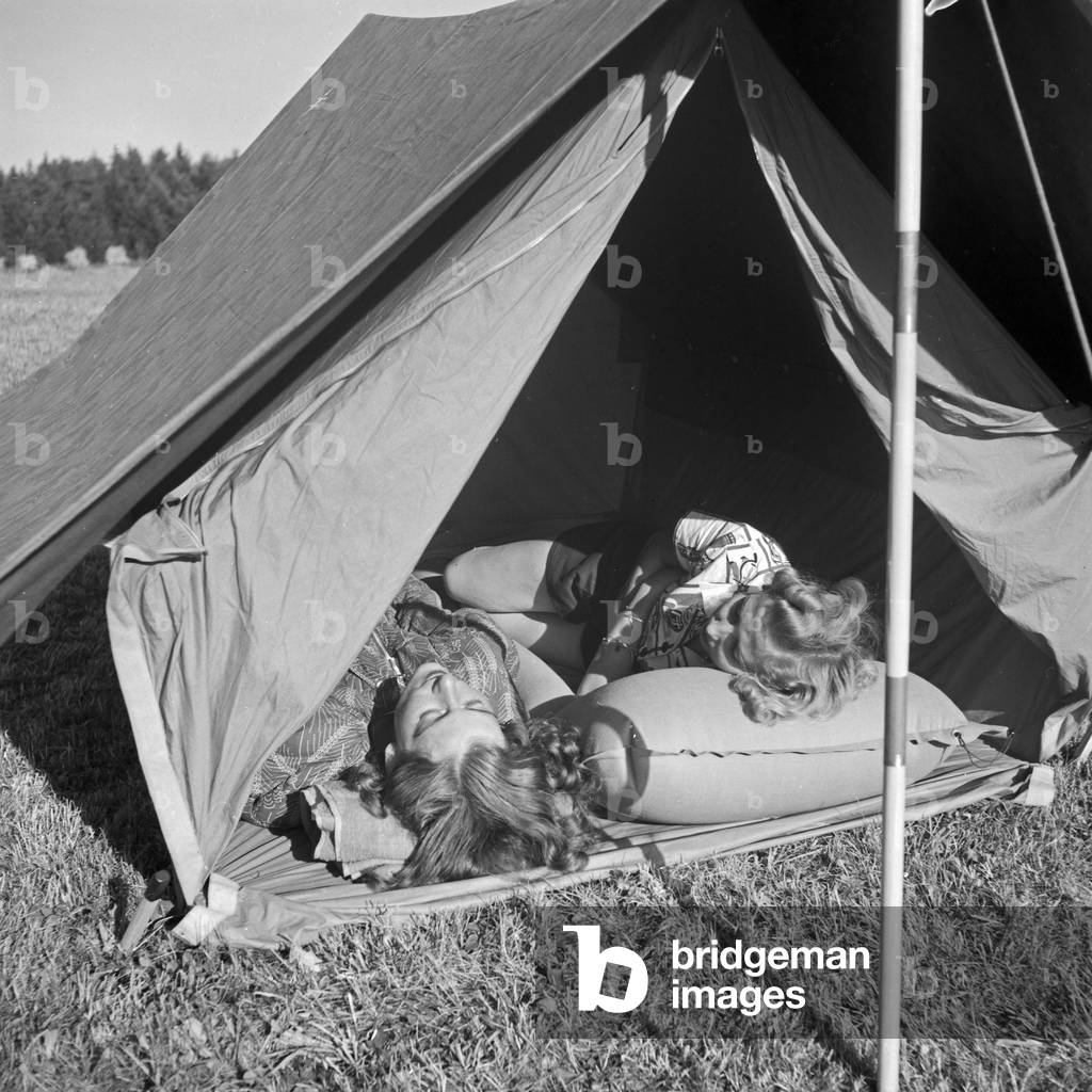 Two women sleeping at their tent, Germany 1930s (b/w photo)
