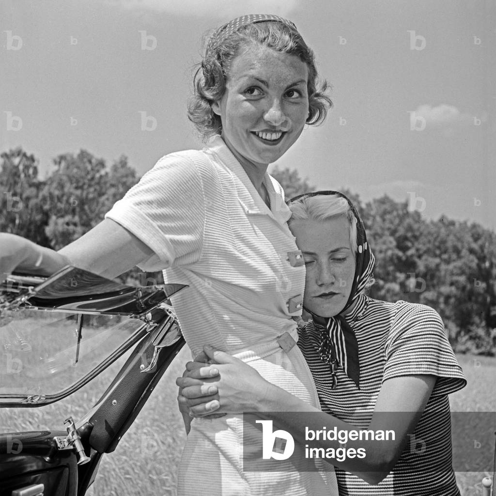 Two young woman with a Ford v8 convertible, Germany 1930s (b/w photo)