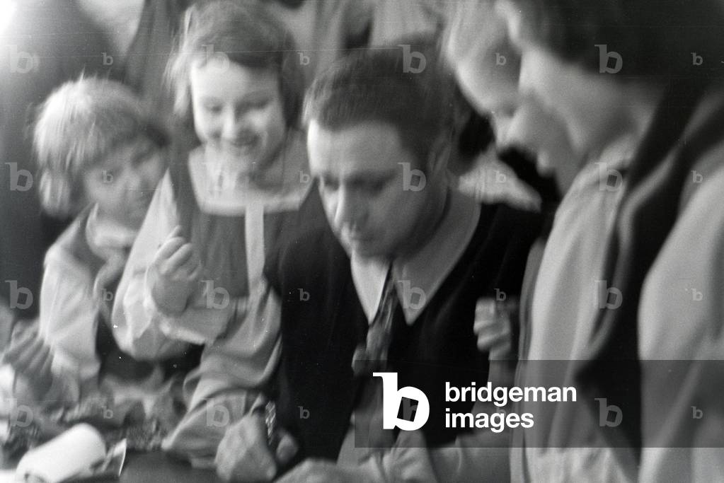 A opera singer signing autographs in the opera in Rome, Italy 1940s (b/w photo)