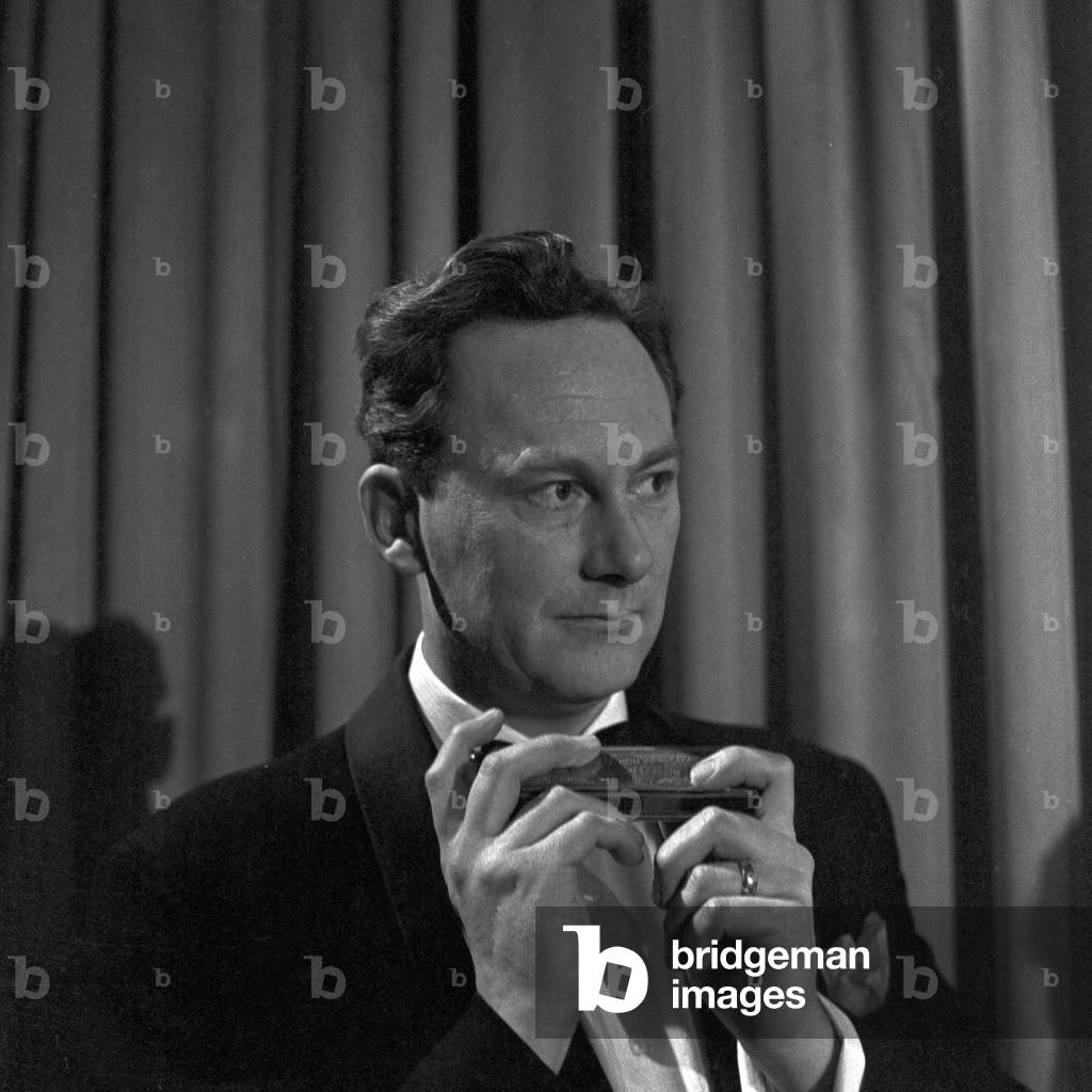 Harmonica player performing at Hamburg, Germany 1950s