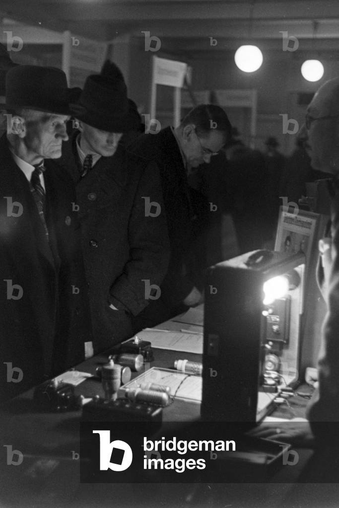 Clients and customers at a booth at Leipzig trade show, Germany 1940s (b/w photo)