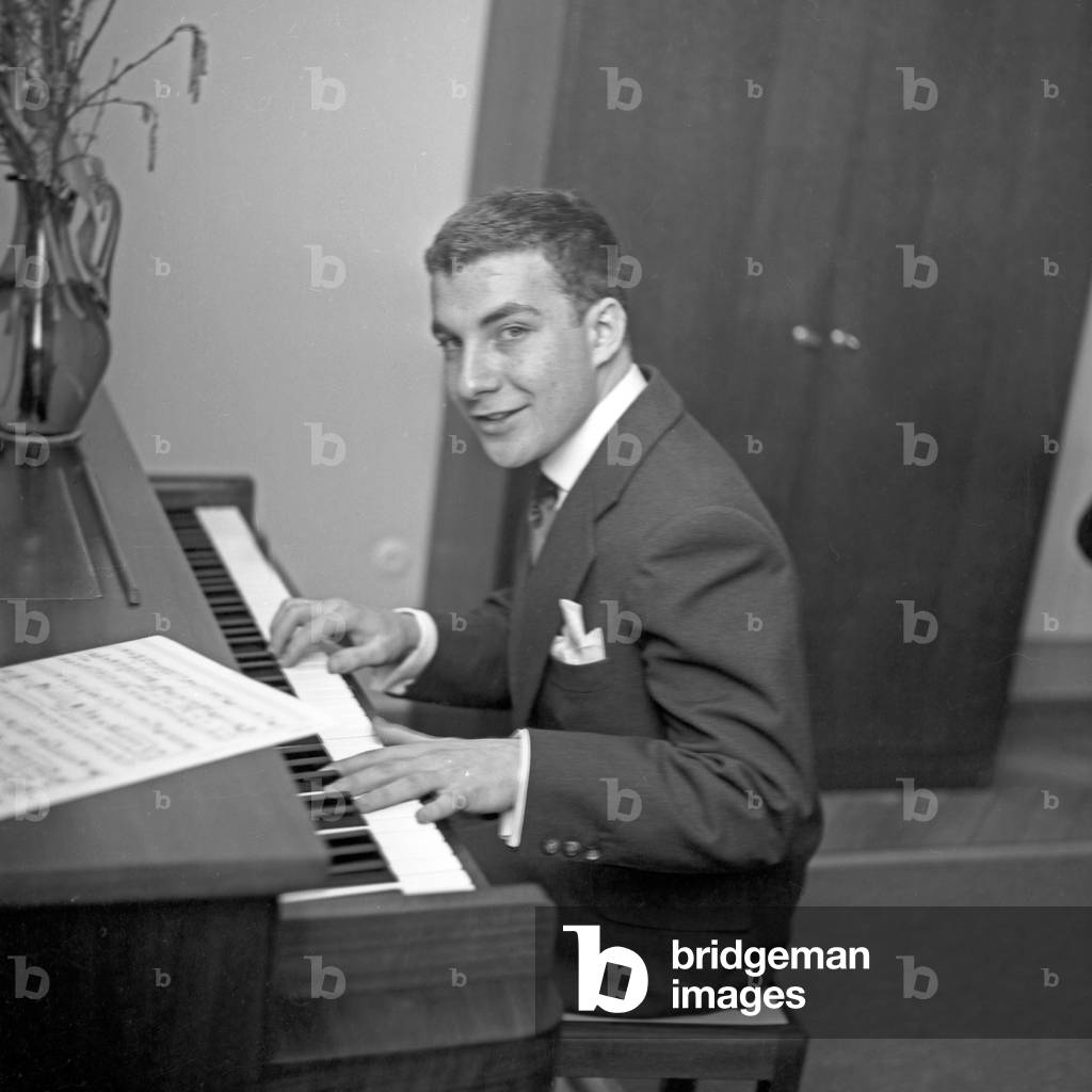 A young man playing the piano at Hamburg, Germany 1950s