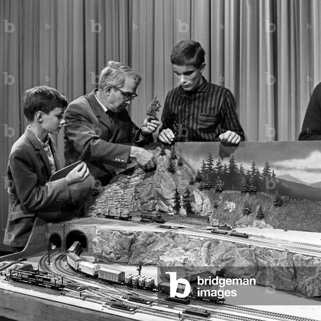 Presenter Friedrich Karl Ries showing model trains at his show 