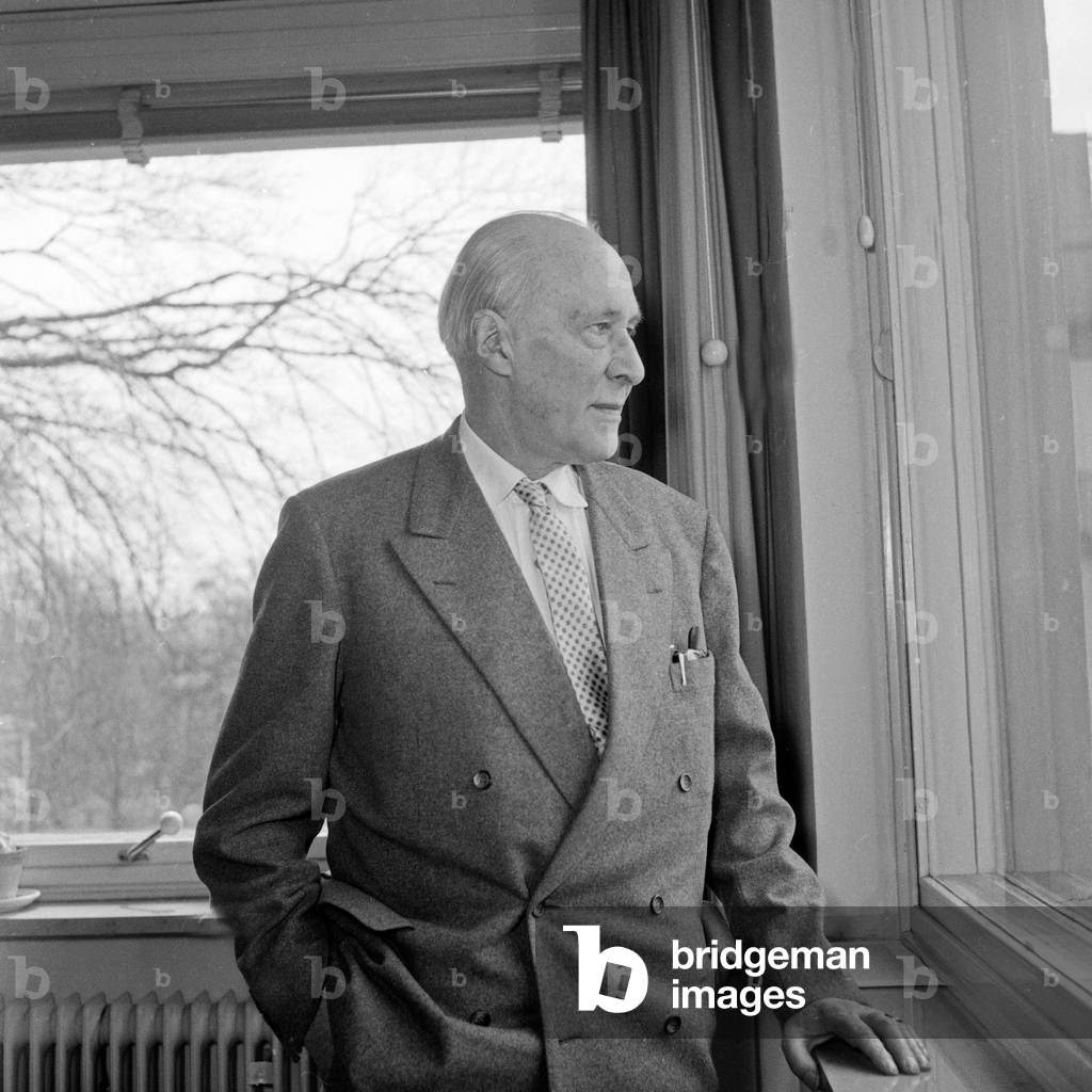 German author, narrator and screenwriter Dr Walther von Hollander at the window of his office, 1956