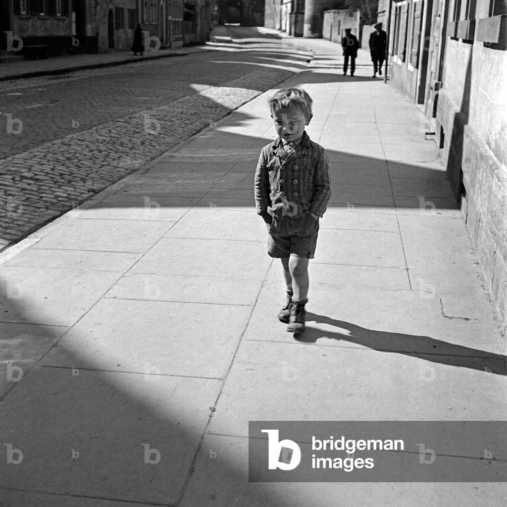 A little philosopher at the streets of Rothenburg ob der Tauber, Germany 1930s (b/w photo)