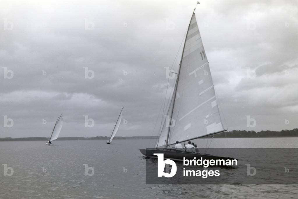 A group of sailors floating over the Chiemsee in a boat, Germany 1930s (b/w photo)
