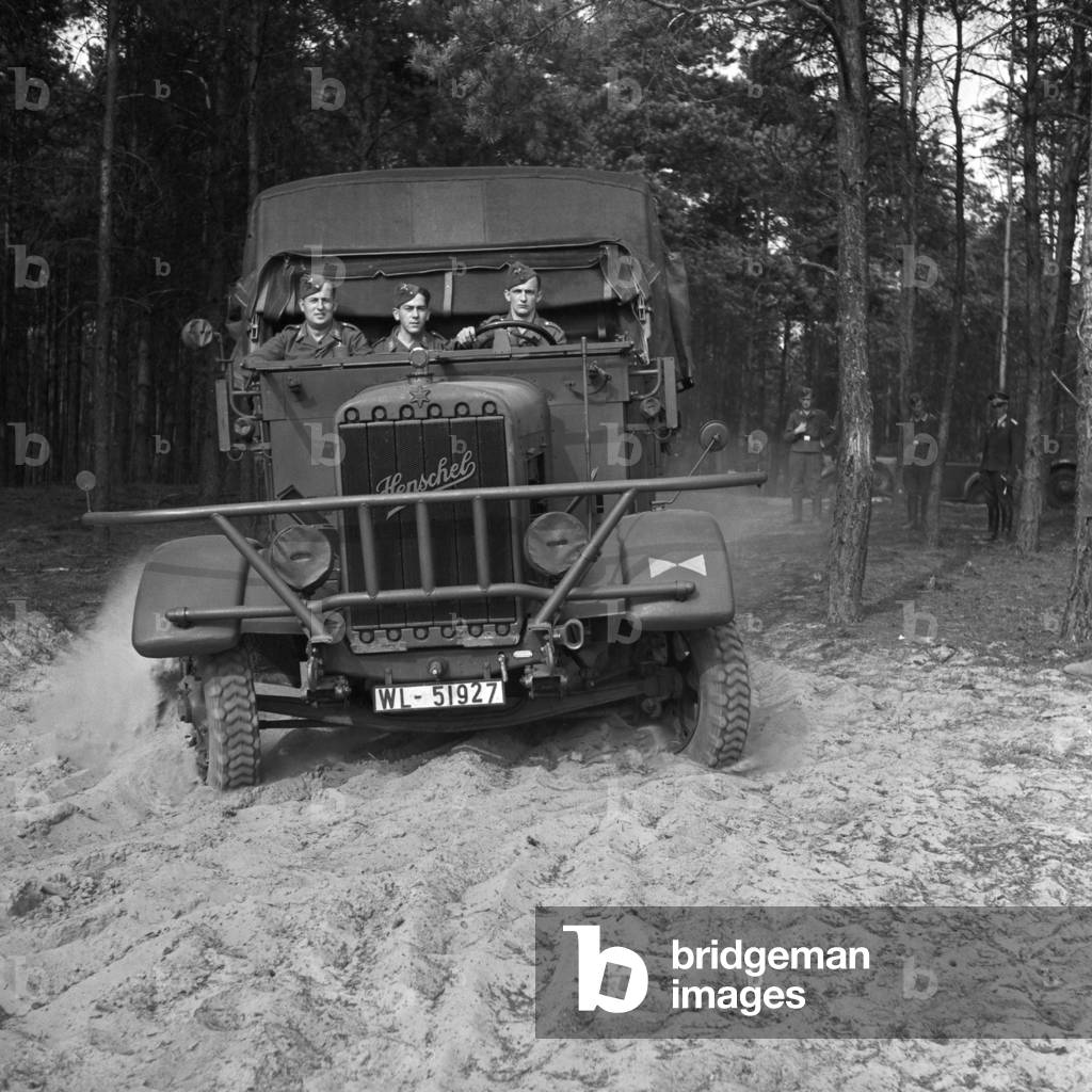 Driving lesson with heavy machinery in the open country, Germany 1940s (b/w photo)