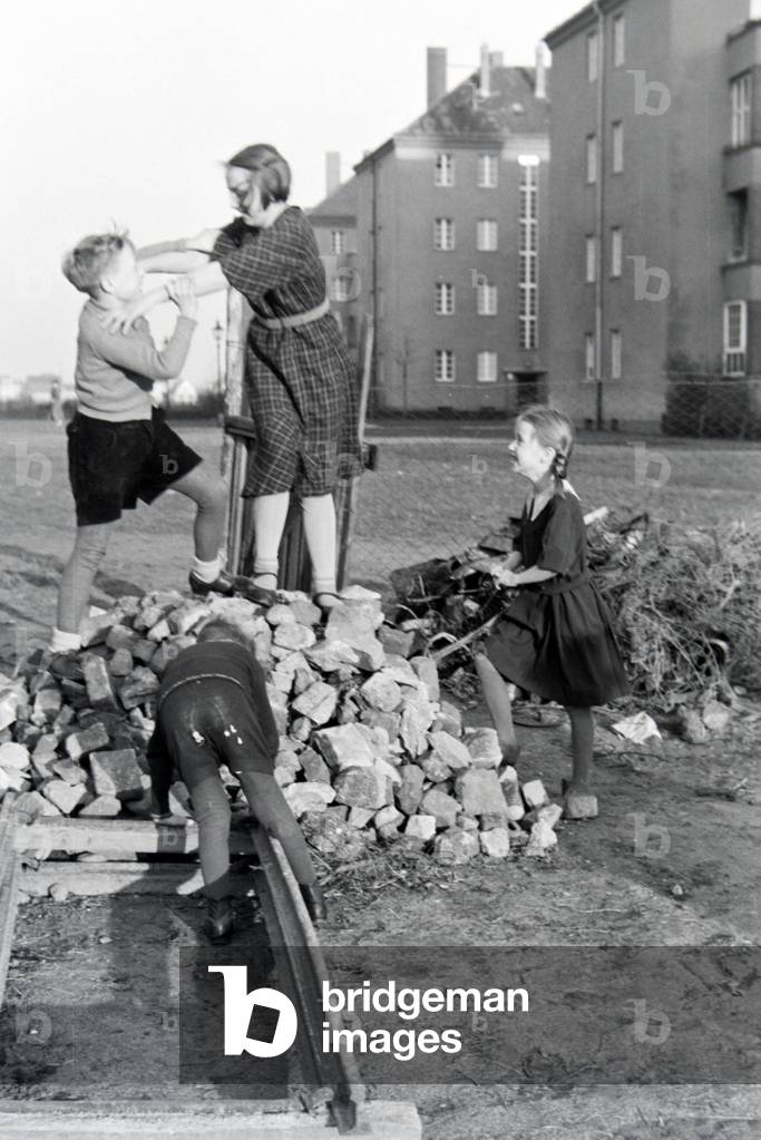 Members of an extended family playing behind the apartment building , Germany 1930s
