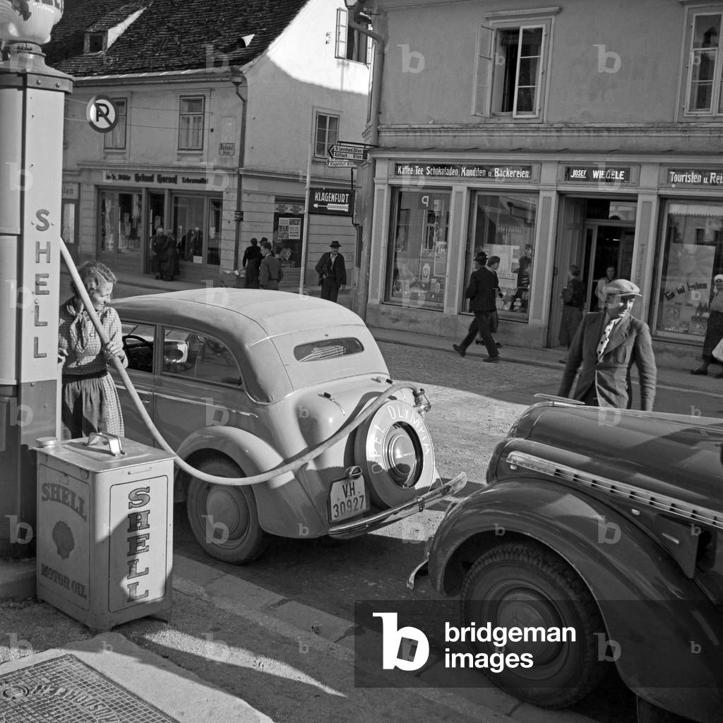Two Opel cars and their drivers at an Shell petrol station in Austria, 1930s (b/w photo)