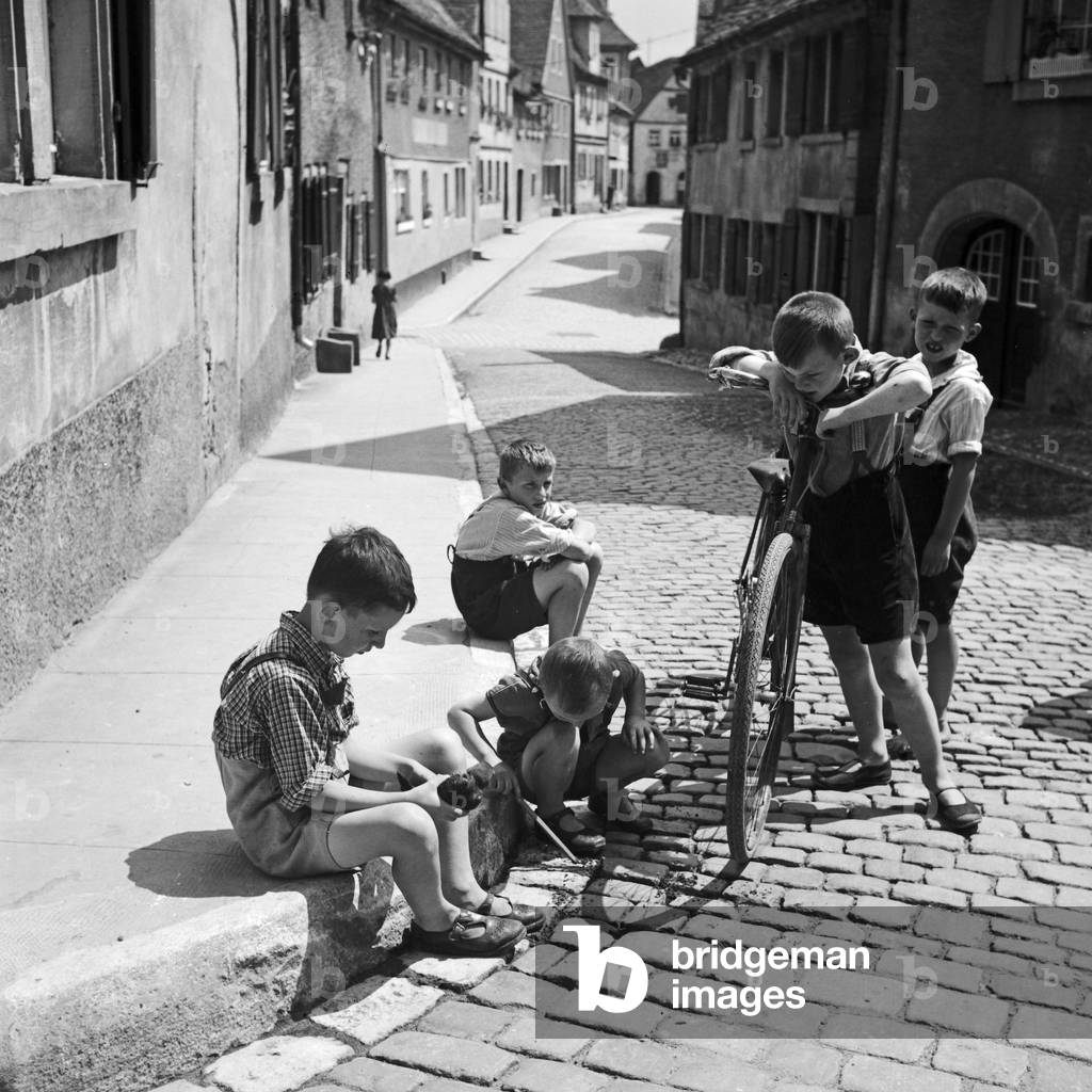 Five little boys playing in the streets of Rothenburg ob der Tauber, Germany 1930s (b/w photo)