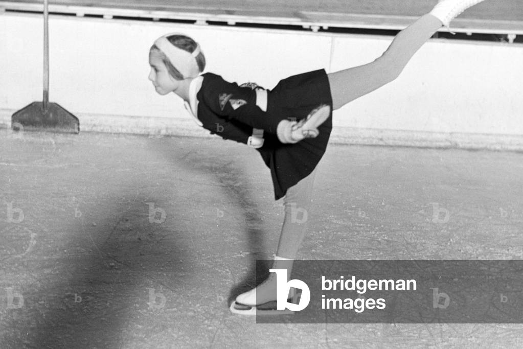 A BDM children figureskaters with the Hitler Youth patches and the swastika emblem on her clothing during a training with the Austrian figureskater and Olympics champion Karl Sch/Sfer, Germany 1930s