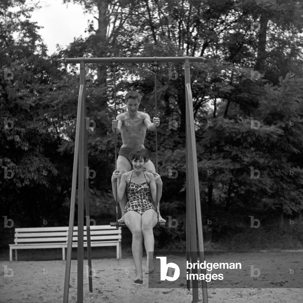 Siblings Maria and Franco Duval doing gymnastics on a playground at Berlin, Germany 1950s