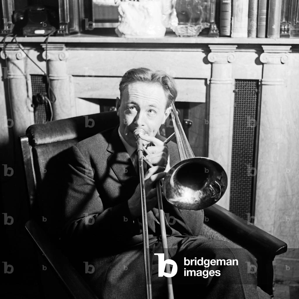 Jazz trombonist Chris Barber exercsing at his hotel room, Germany 1950s