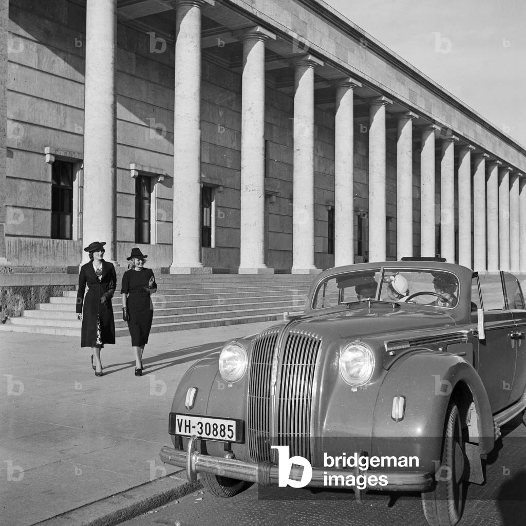 Driving through Munich with an Opel model Admiral, Germany 1930s (b/w photo)