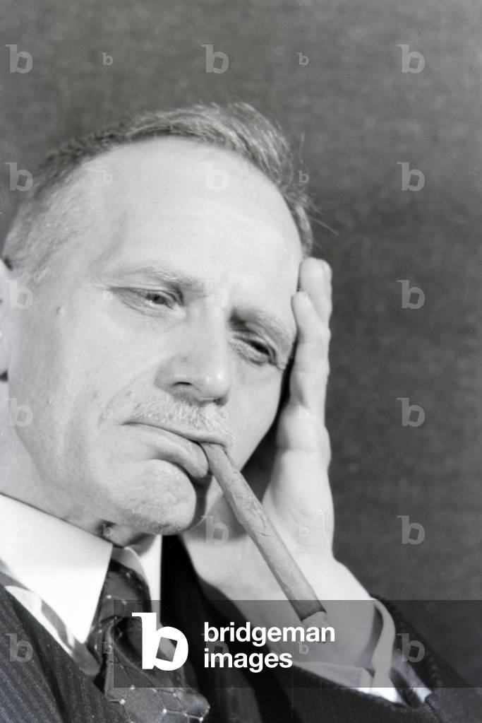 A man smoking a cigar for an advertising campaign, Germany 1930s (b/w photo)