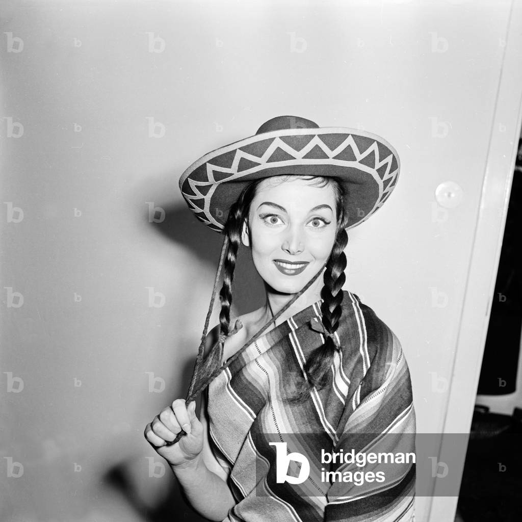 doing a promotional photo shoot wearing a poncho and a sombrero hat, Germany 1950s