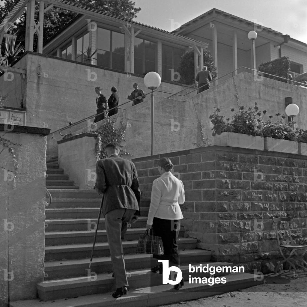 People on the stairs to a restaurant at Wildbad in Black Forest, Germany 1930s (b/w photo)