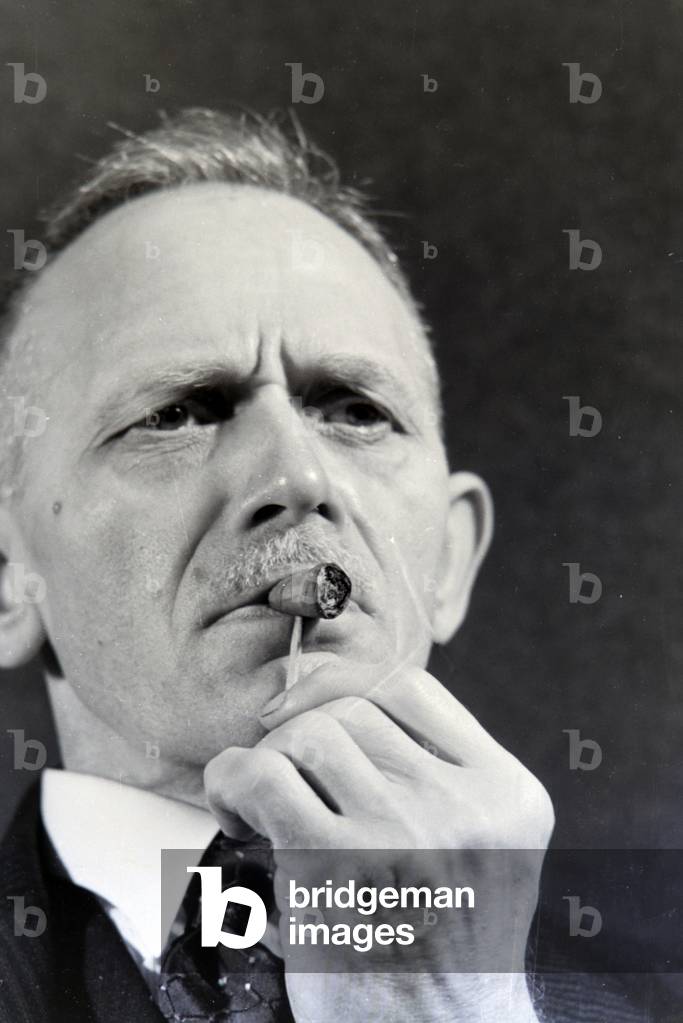 A man smoking a cigar for an advertising campaign, Germany 1930s (b/w photo)