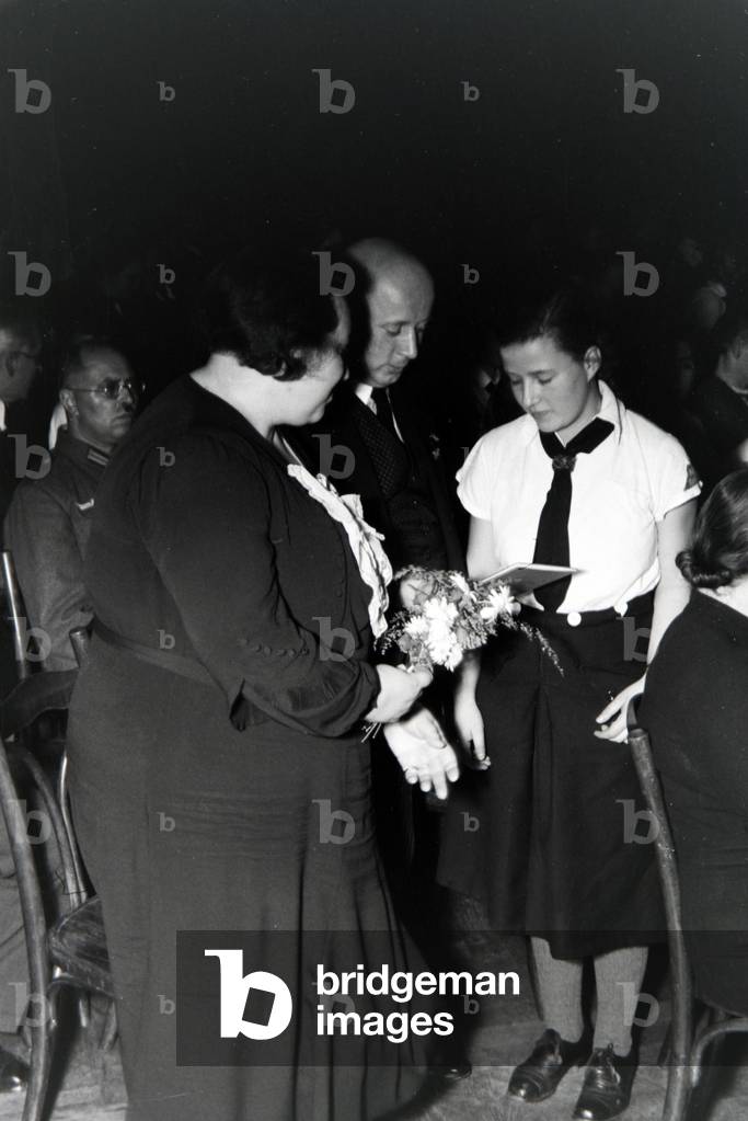 The parents of an extended family at the concession oh the Honour Cross, Germany 1930s (b/w photo)