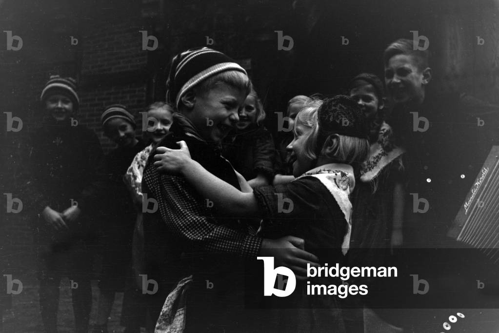 Children dancing in traditional costume of Ammerland near Bad Zwischenahn at the Oldenburg area, Germany 1930s (b/w photo)