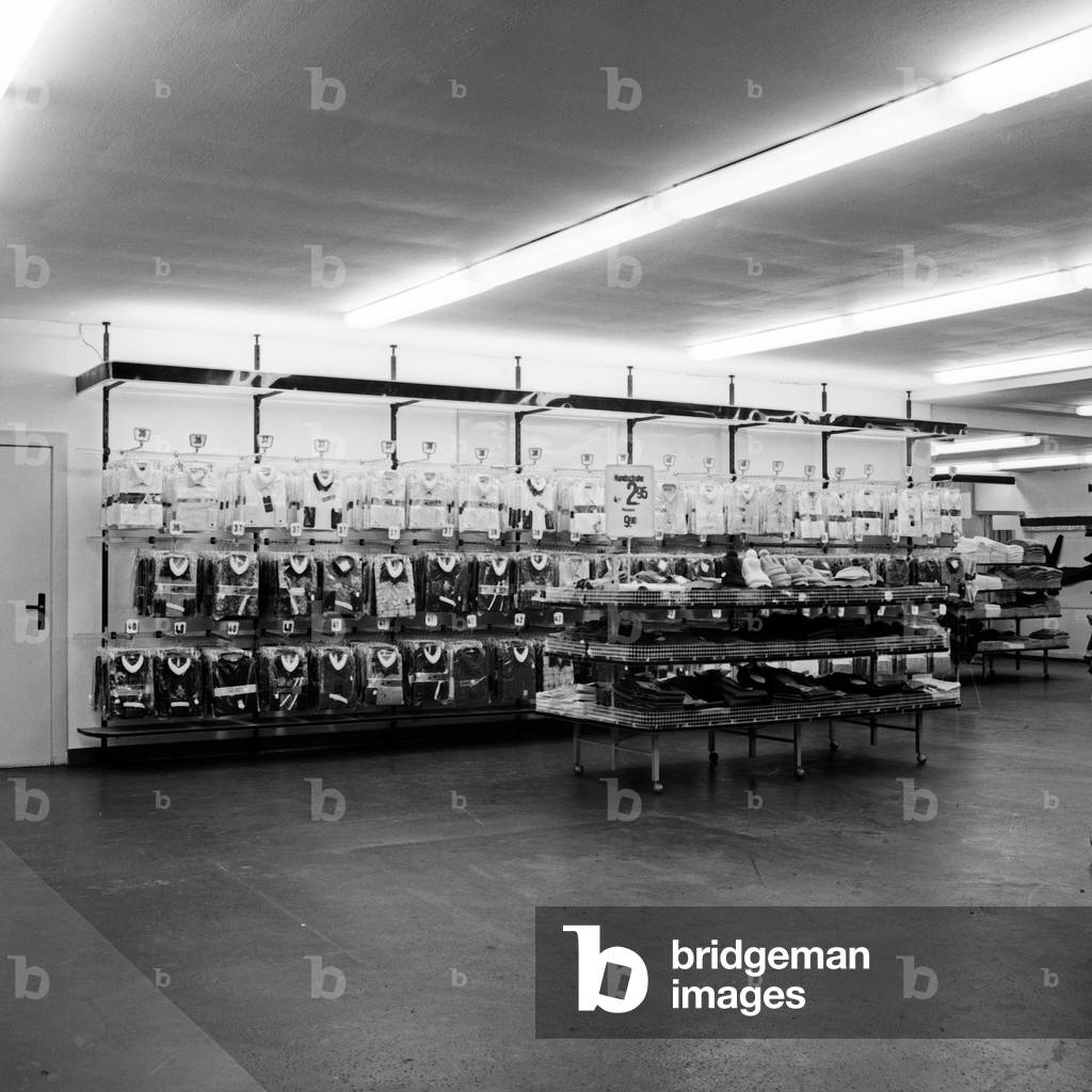 Filled shelving at a men's fashion store in Hamburg, Germany 1960s