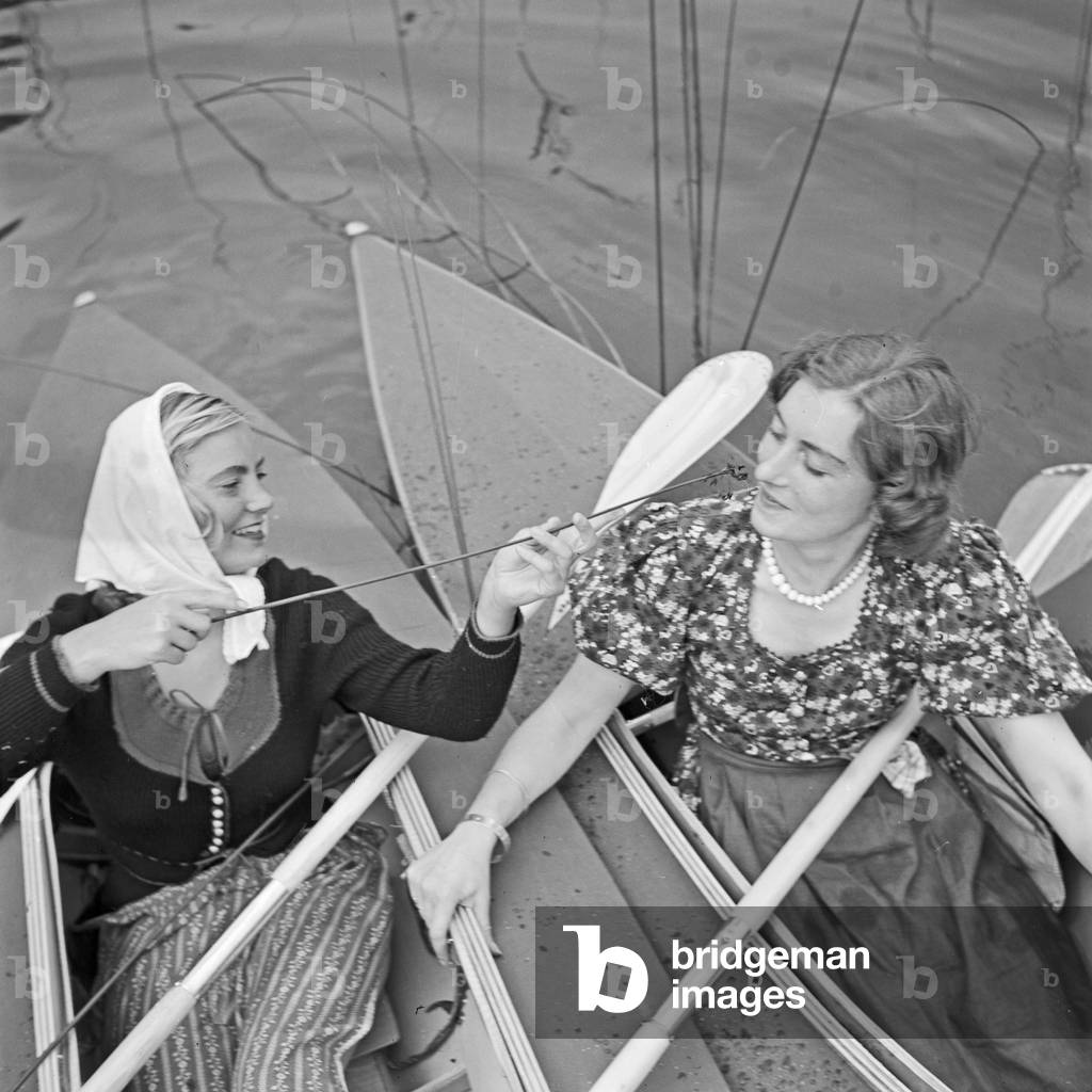 Two young women at a boardwalk on the shore of a lake in the Wachau area, Germany 1930s (b/w photo)