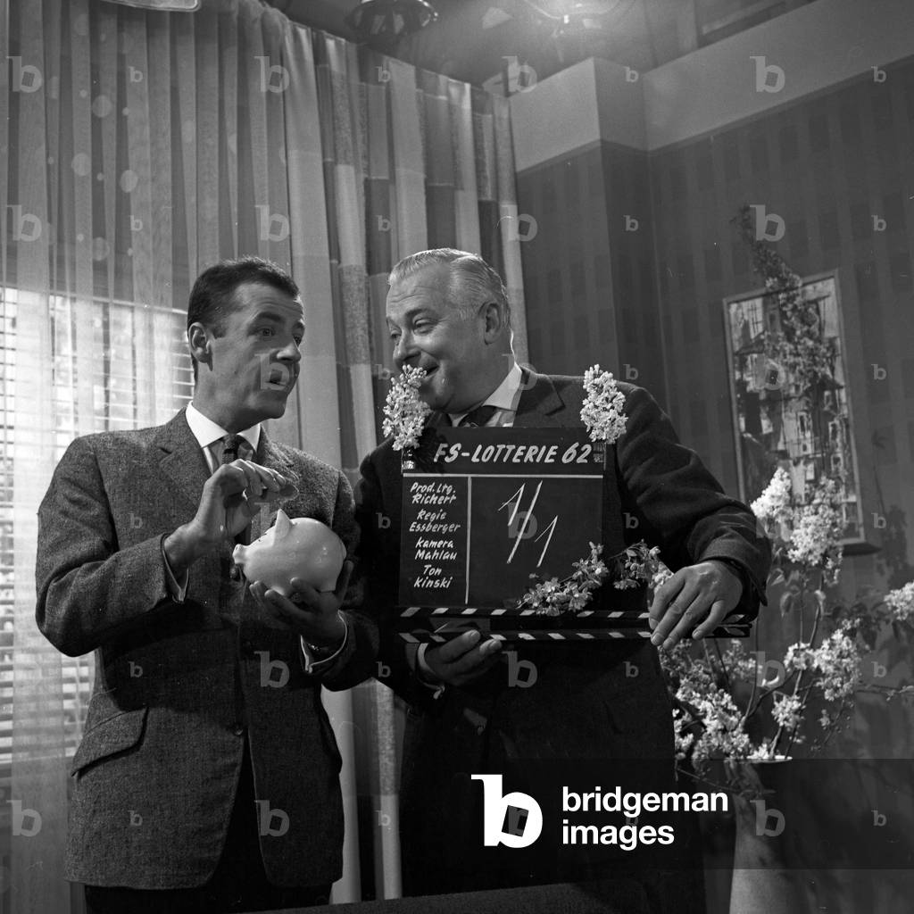 TV presenter Chris Howland and production manager Richert promoting Germany TV lottery 1962 at Hamburg, Germany 1960s