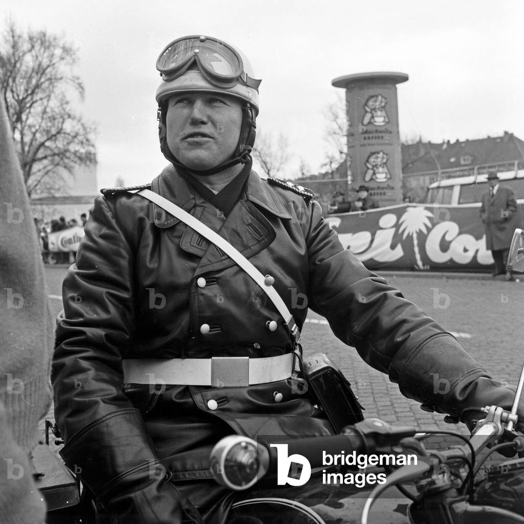 Policeman on a motorbike at the 4th stage of International Afri Cola Germany cycle racing with the tour from Kassel to Hanover, Germany 1960s