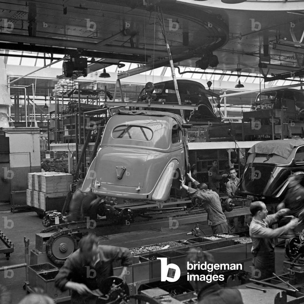 Workers at the conveyor belt of the Ford factory at Cologne, Germany 1930s (b/w photo)