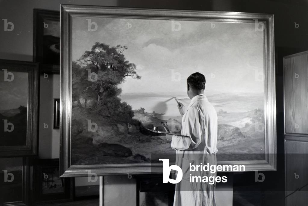 The artist, painter Hermann Gradl working, Painting on his landscape picture, painting, Germany 1930s (b/w photo)