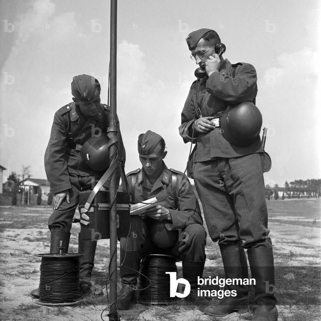 Telephonists communicating with their backwarding operator, Germany 1940s (b/w photo)