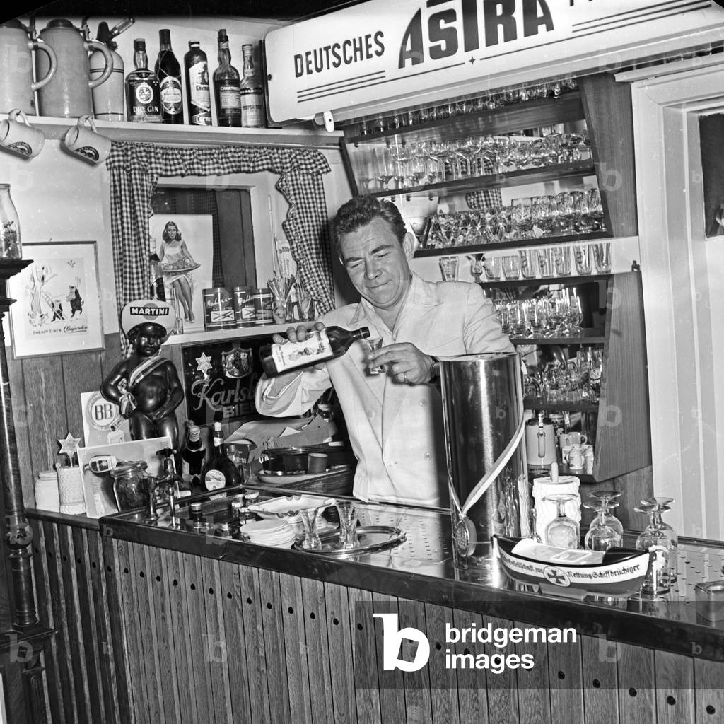 Peter Frankenfeld at his bar in the cellar of his house at Wedel near Hamburg, Germany 1950s