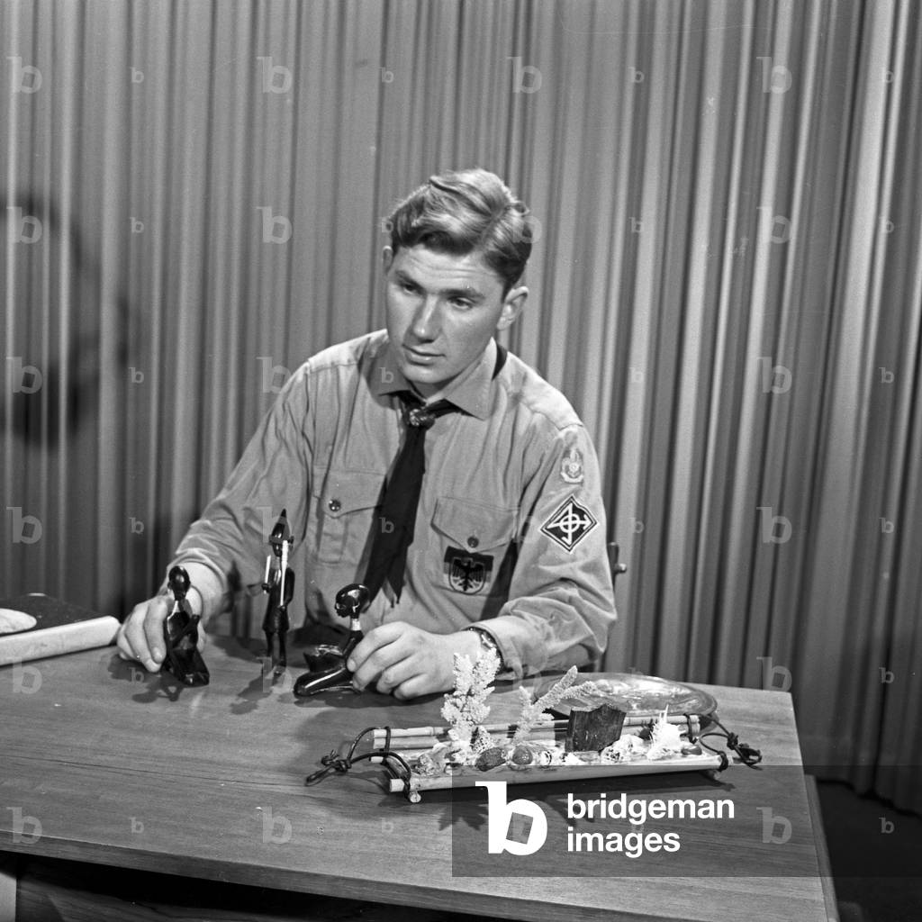 German boy scout Helfried Weyer explaining African tribal art at German TV station NDR at Hamburg, Germany 1960s
