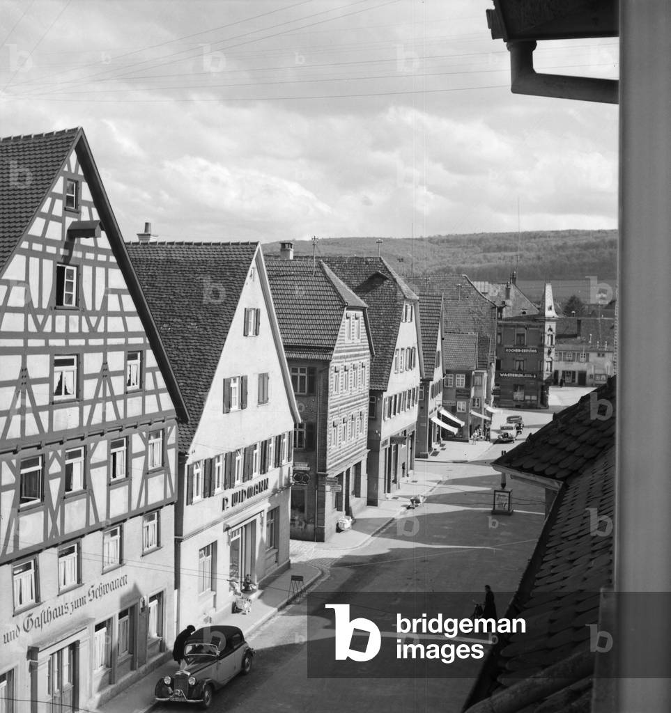 On the way through German landscape and small town, Germany 1930s (b/w photo)