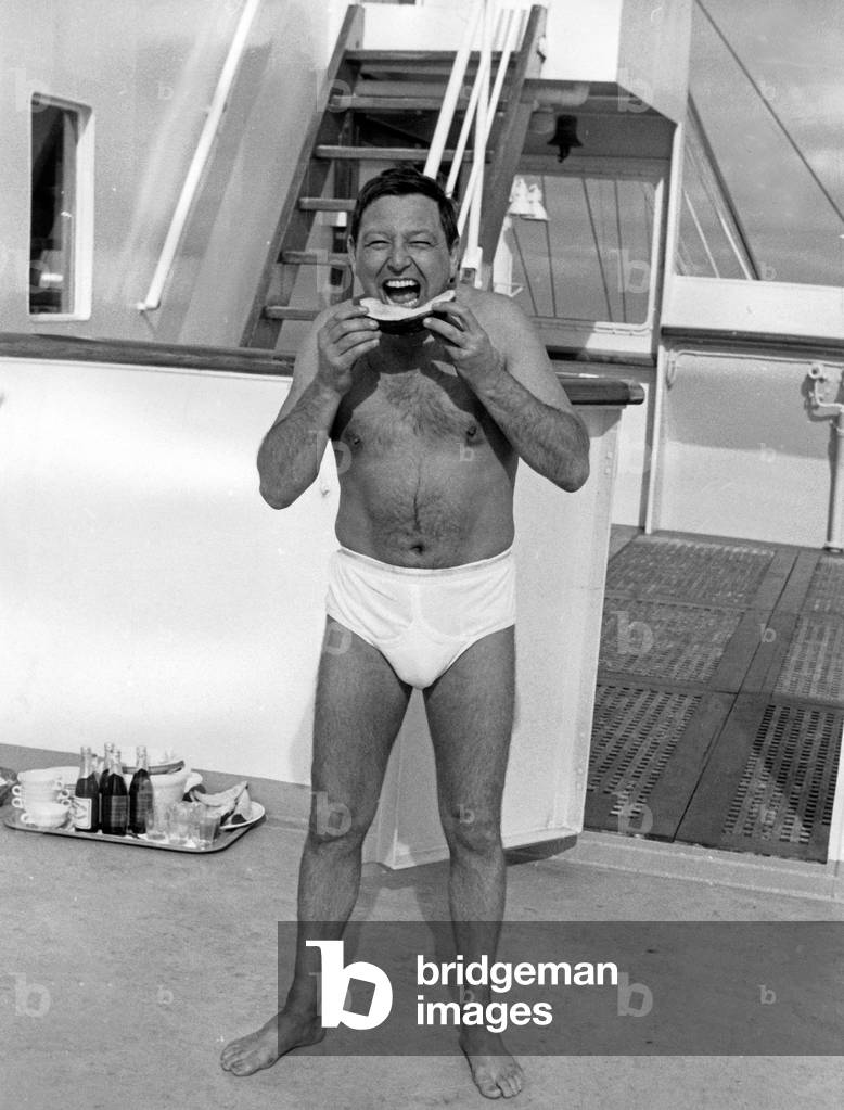 German cabaret artist Wolfgang Neuss eating a piece of water melon, Germany 1960s