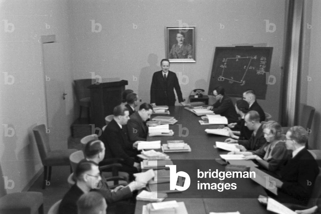 Travellers and staff members at a huge office of a travel agency in Berlin, Germany 1930s (b/w photo)
