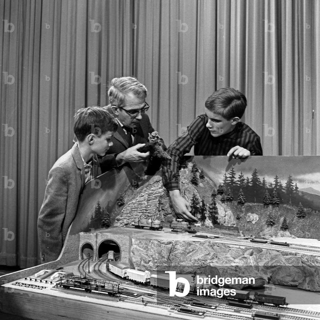 Presenter Friedrich Karl Ries showing model trains at his show 