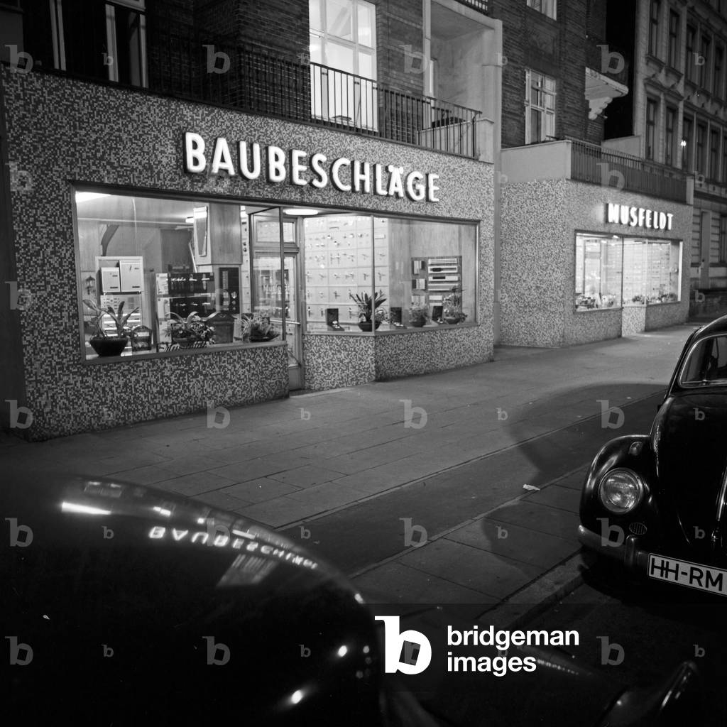 Front side of the outlet of architectural hardware company Musfeldt at Hamburg by night, Germany 1960s