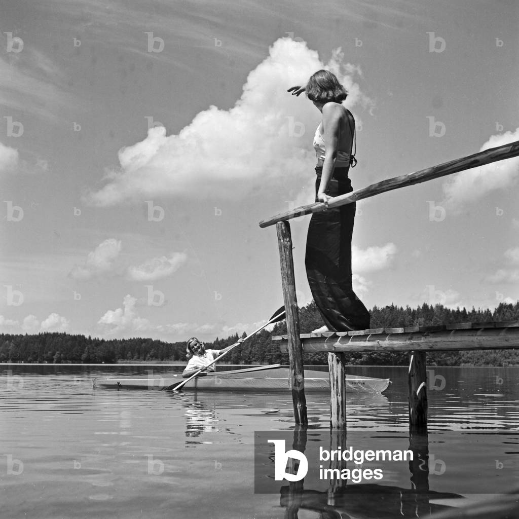 Two young women at a boardwalk on the shore of a lake in the Wachau area, Germany 1930s (b/w photo)