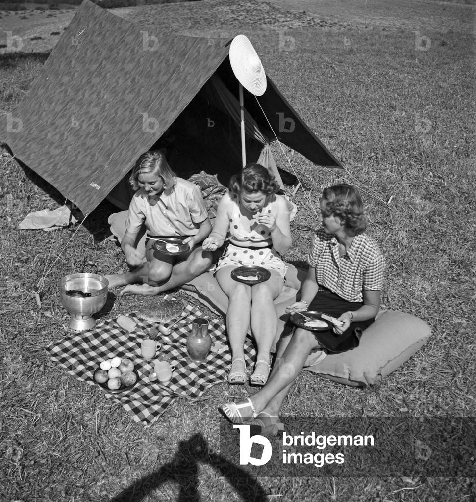 Young woman by their tent on summer vacation, Germany 1930s (b/w photo)