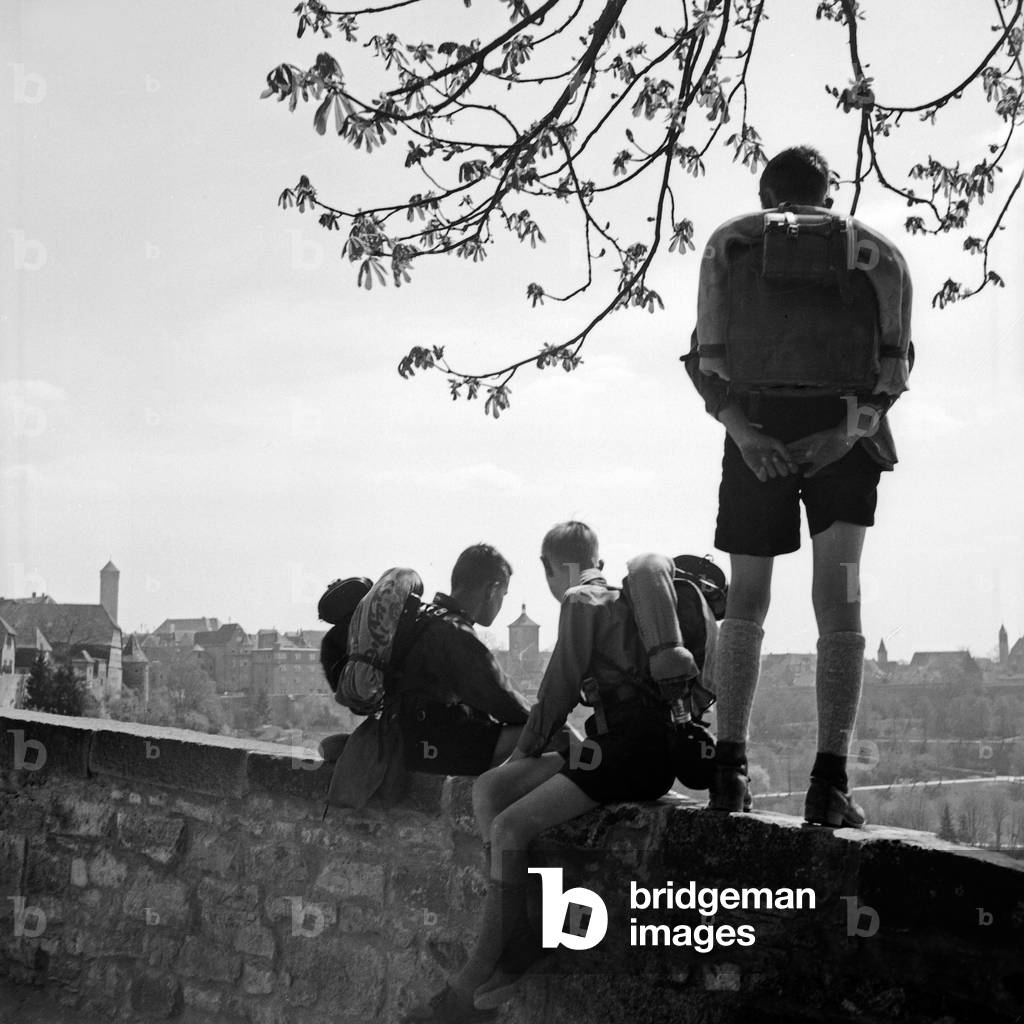 Three Hitler youth enjyoing a panorama from a watchout, Germany 1930s (b/w photo)