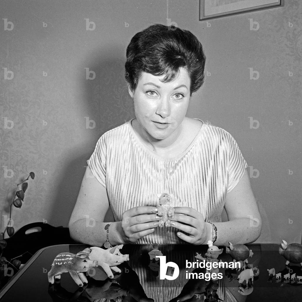 Austrian opera singer Melitta Muszely with her piggy collection at Hamburg, Germany 1960s